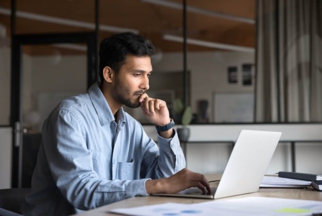 Businessman on laptop thinking