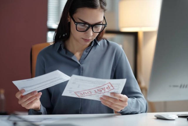 Business woman going through tax bills