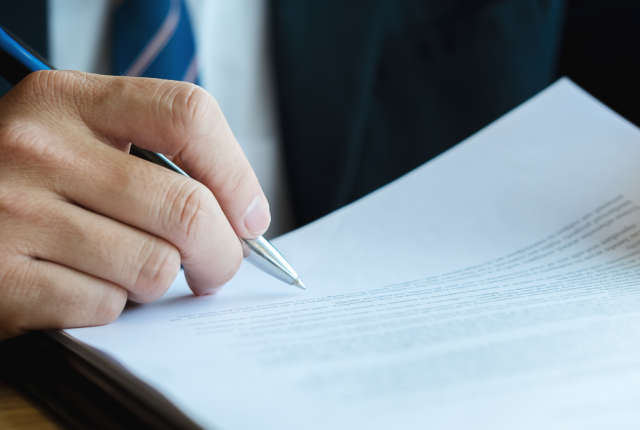 Company director signing paper1300x700.png
